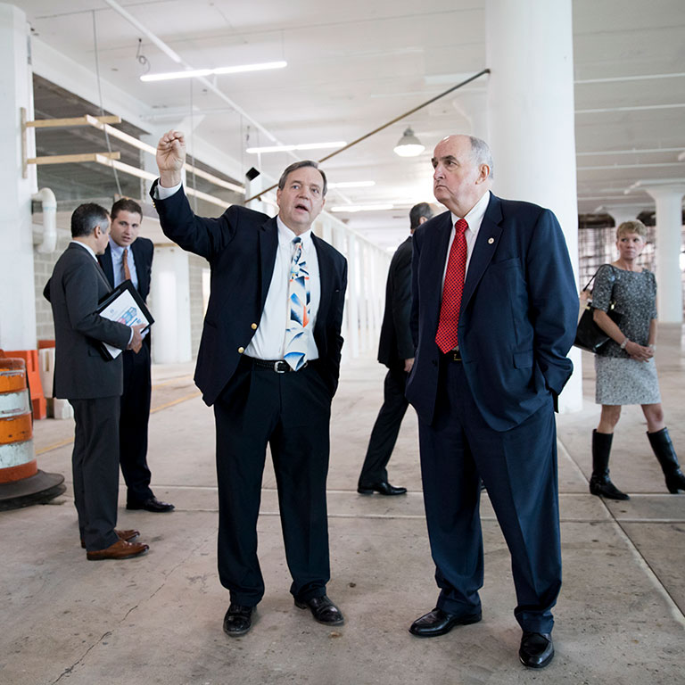 IU President Michael McRobbie visits a construction site with business leaders. 